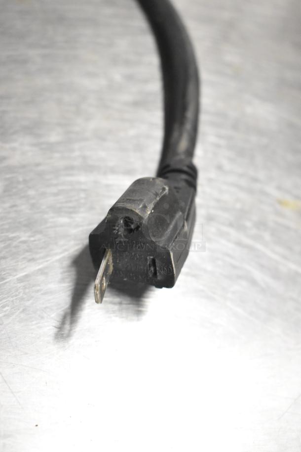 Black 120V power plug of Cadco Unox Roberta XAF003 convection oven on silver surface.