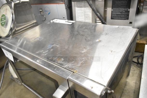 2016 Amana RCS10TS stainless steel commercial microwave, 120 volts, visible surface wear, ideal for countertop use.