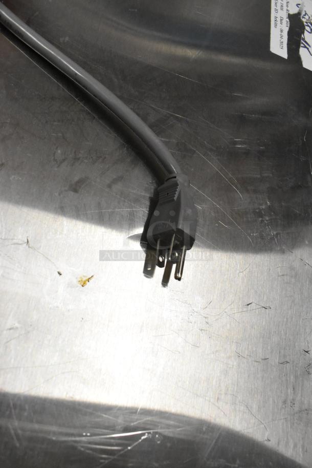 Power cord for 2016 Amana RCS10TS stainless steel commercial countertop microwave oven, 120 volts, shown on metallic surface.