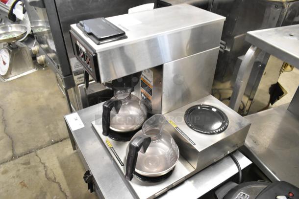 Bunn VP17-3 stainless steel commercial coffee machine with 3 burners and 2 coffee pots, 120 volts, 1 phase, in good condition.
