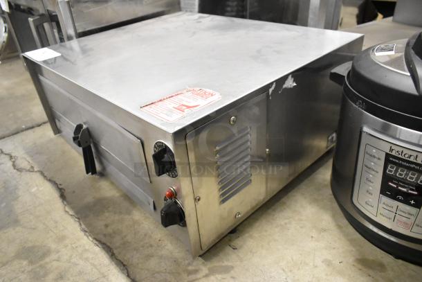 Wisco 560 stainless steel countertop pizza oven, electric-powered, 120 volts, 1 phase. Features control knobs and vented panel.