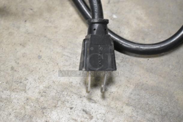 Power plug of Wisco 560 stainless steel countertop pizza oven, 120 volts, 1 phase, shown on concrete surface.