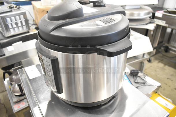 Instant Pot Lux 80 countertop pressure cooker, stainless steel, black lid, digital controls, 120 volts, 1 phase, excellent condition.