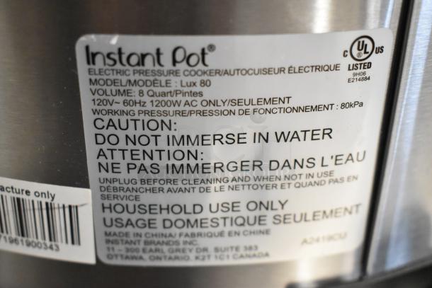 Instant Pot Lux 80 metal countertop pressure cooker label, 120 volts, 1 phase, 8-quart capacity, model and safety info visible.