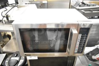 2019 Amana RCS10TS stainless steel commercial countertop microwave oven, with keypad and display, model label visible.