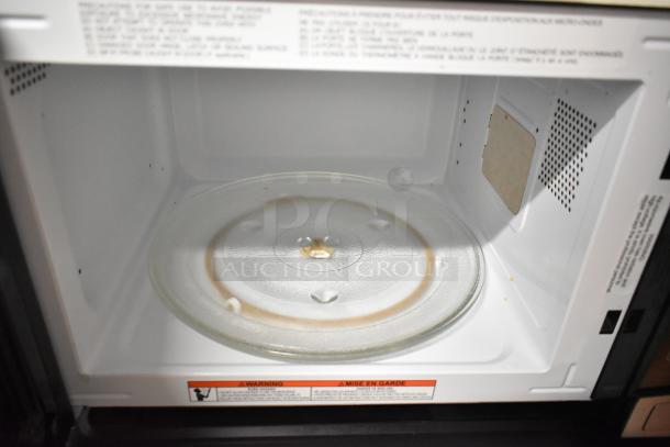Frigidaire EMW1120-B-3ACOM stainless steel countertop microwave oven interior with glass plate. 120 Volts, 1 Phase.
