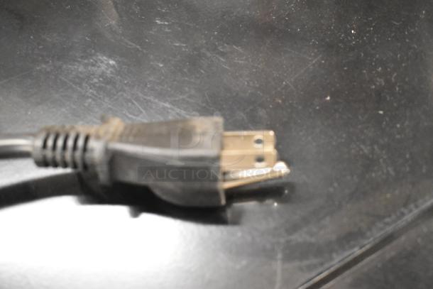 Close-up of power plug for Frigidaire EMW1120-B-3ACOM stainless steel countertop microwave oven.
