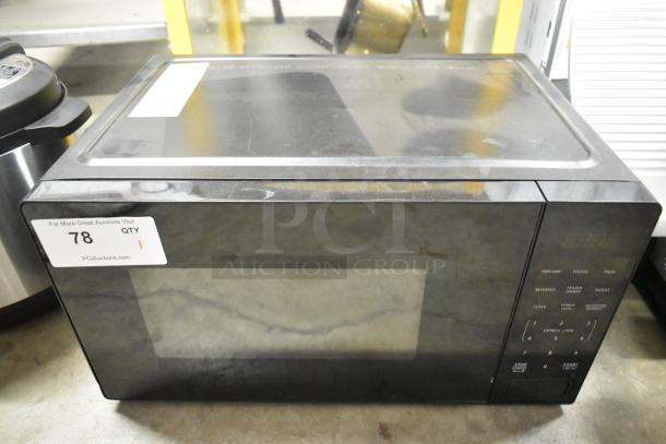 Walmart countertop microwave oven, model MS54100112162, black, 120 volts, with digital controls and label #78 visible.