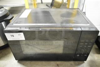 Walmart countertop microwave oven, model MS54100112162, black, 120 volts, with digital controls and label #78 visible.