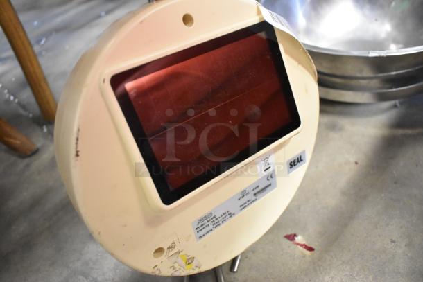 Detecto SCS30 30-pound hanging produce scale, beige, with digital display and seal sticker. Some wear visible.