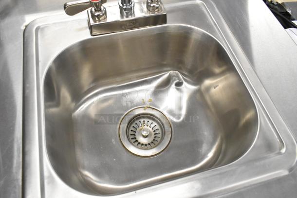 QualServ WMSC24MS stainless steel commercial portable single bay sink with visible dent, mounted on commercial casters.
