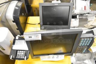 IBM and Toshiba monitors with a credit card reader, auction tag reads "86 QTY x3". Good condition, ideal for retail use.