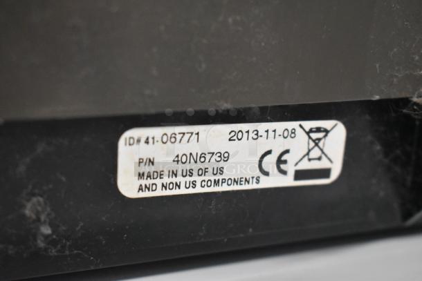 Gray metal cash drawer label showing ID# 41-06771, date 2013-11-08, P/N 40N6739, and made in US with CE marking.