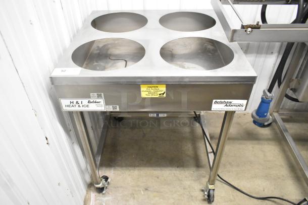 Belshaw Adamatic H&I Stainless Steel Glazing Station on casters, featuring four openings, industrial labels, and caution signage.