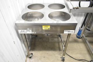 Belshaw Adamatic H&I Stainless Steel Glazing Station on casters, featuring four openings, industrial labels, and caution signage.