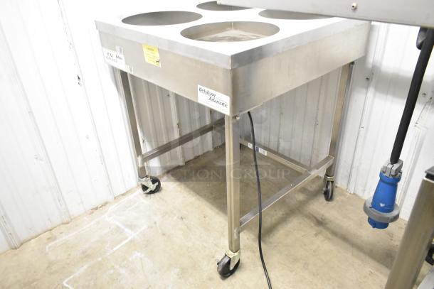 Belshaw Adamatic H&I stainless steel floor-style glazing station on commercial casters, with branded label and caution tag.
