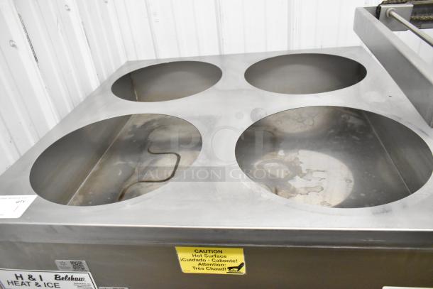 Belshaw Adamatic H&I stainless steel glazing station with four circular wells, on commercial casters; caution label visible.