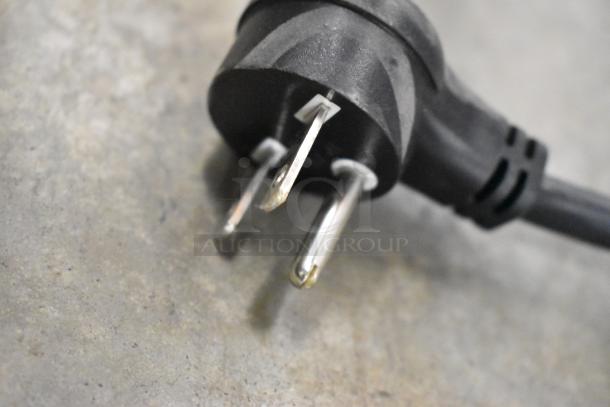 Close-up of a three-prong plug, part of the Belshaw Adamatic H&I stainless steel glazing station.