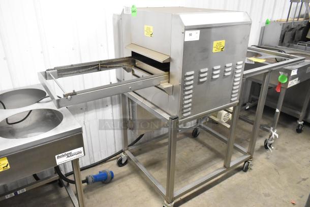 Belshaw TG50 stainless steel thermoglazing station on casters, 208 volts, 1 phase. Features include conveyor and caution labels.