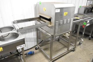 Belshaw TG50 stainless steel thermoglazing station on casters, 208 volts, 1 phase. Features include conveyor and caution labels.