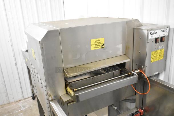 Belshaw TG50 stainless steel thermoglazing station on casters. Features include 208 volts, 1 phase, with caution signage.