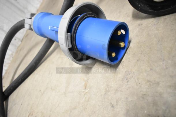Belshaw TG50 power connector showing blue plug with three metal prongs and black cable on a concrete surface.