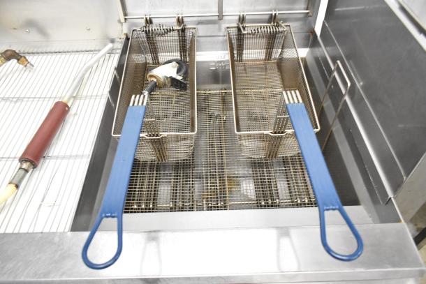 Giles EOF-24 stainless steel 2-bay deep fat fryer with center dumping station, electric-powered, on commercial casters.