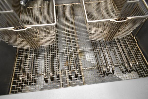 Giles EOF-24 stainless steel 2-bay deep fat fryer with center dumping station; shown with wire baskets, on casters.