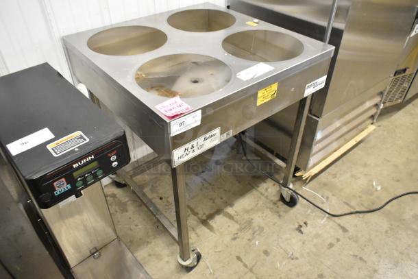 Belshaw Adamatic H&I-4 stainless steel glazing station on casters. Features four circular openings, 208-240V, good condition.
