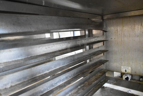 Baxter stainless steel mini rotating rack oven interior, natural gas powered, with dual pan rack on commercial casters.