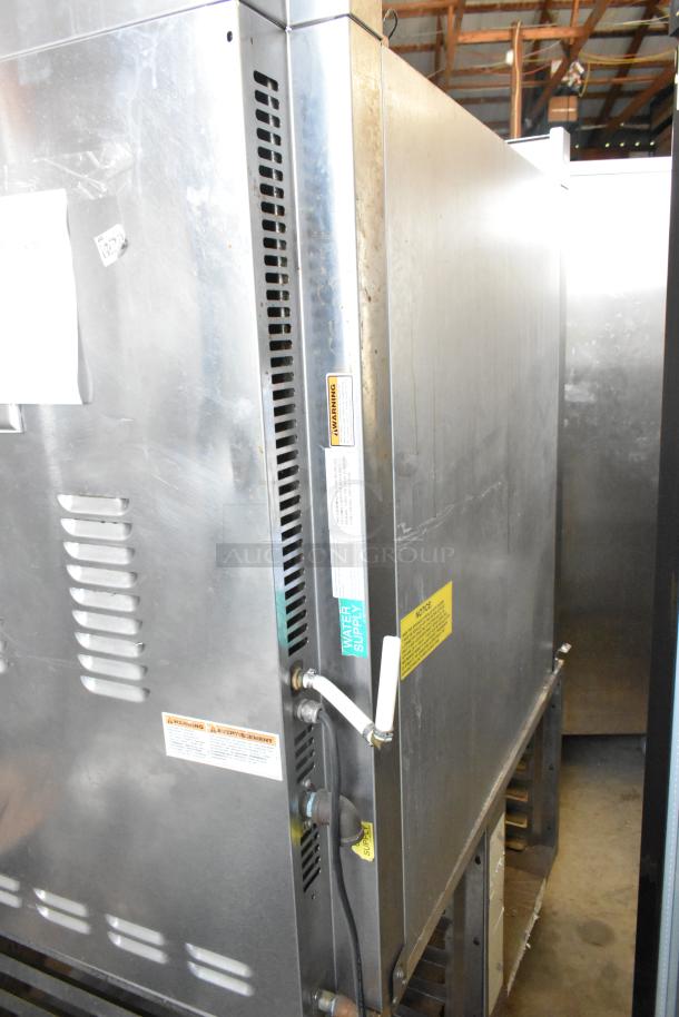 Baxter stainless steel commercial rotating rack oven, natural gas-powered, with dual pan rack, on commercial casters, visible labels.