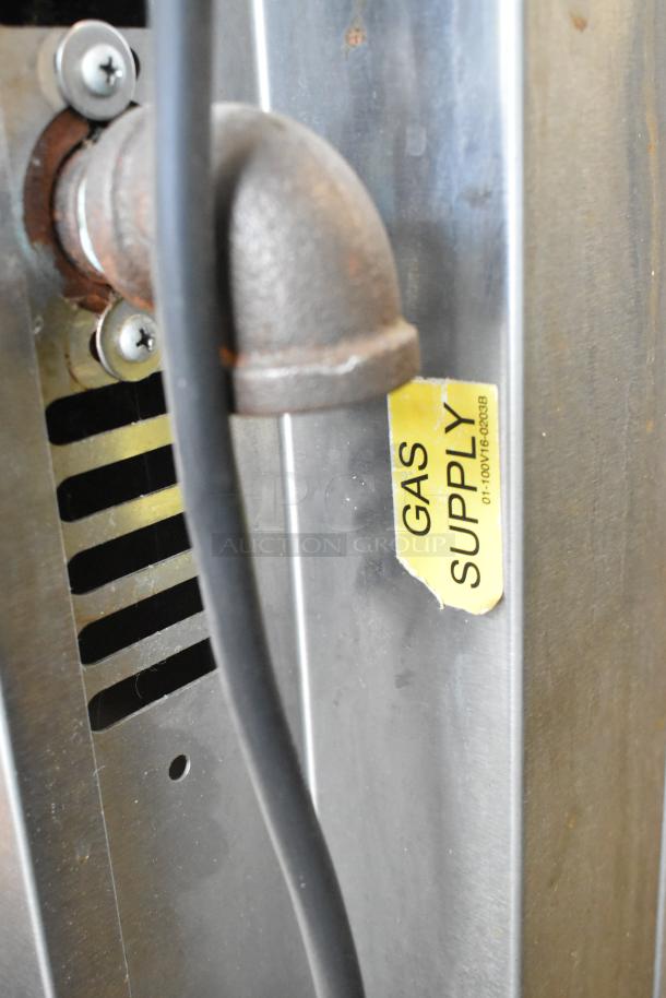 Baxter stainless steel natural gas mini rotating rack oven, showing gas supply pipe and label. Includes dual pan rack.