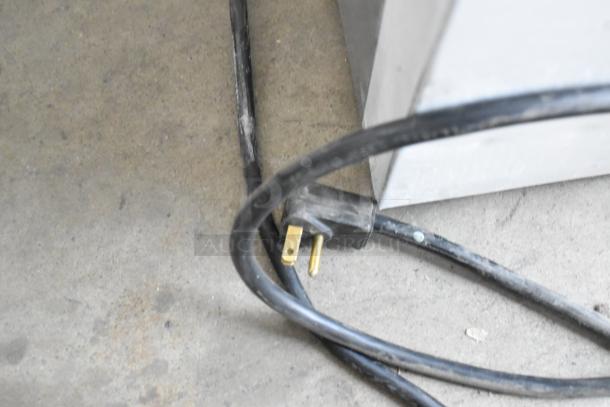 Power cord of 2019 Habco SE18 reach-in cooler, visible plug and cable on concrete floor.