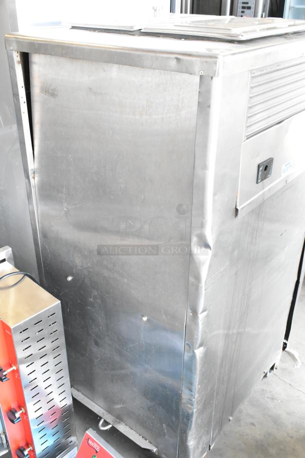 Taylor 754-27 stainless steel 2-flavor soft serve ice cream machine, floor style, with twist feature, on commercial casters.
