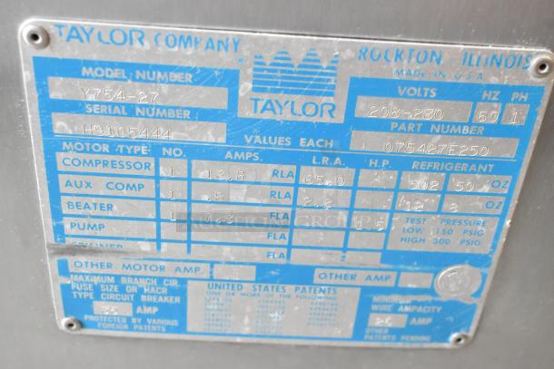 Label on Taylor 754-27 stainless steel commercial soft serve ice cream machine; shows model, voltage, and specifications.