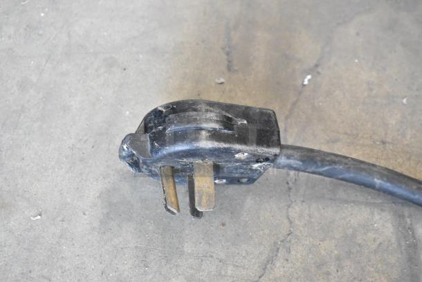 Close-up of a plug and cable for a Taylor 754-27 soft serve machine, showing signs of wear.