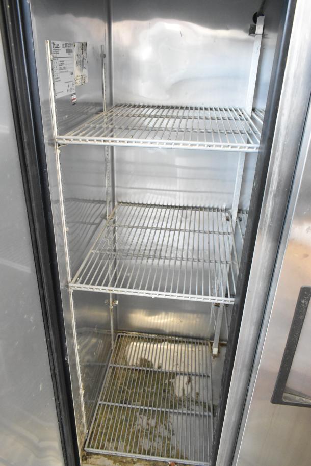 True T-35 stainless steel commercial cooler with two doors and poly-coated racks. Visible interior label and moderate wear.