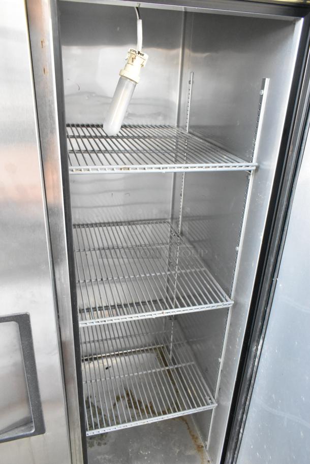 True T-35 stainless steel commercial 2-door reach-in cooler with poly coated racks, 115 volts, 1 phase, interior view.