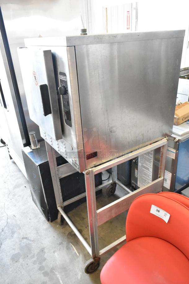 Hobart HC24EA5 stainless steel single-deck steam cabinet on stand with casters, electric, 208/240V, model visible.