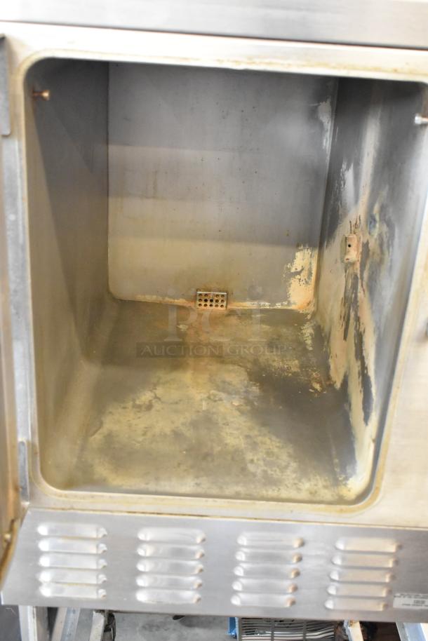 Hobart HC24EA5 stainless steel single deck steam cabinet interior with visible wear, on a stand with commercial casters.