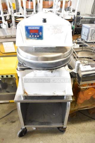 DoughPro commercial countertop dough press on stainless steel stand. Visible wear. Operates on 115 volts, 1 phase.