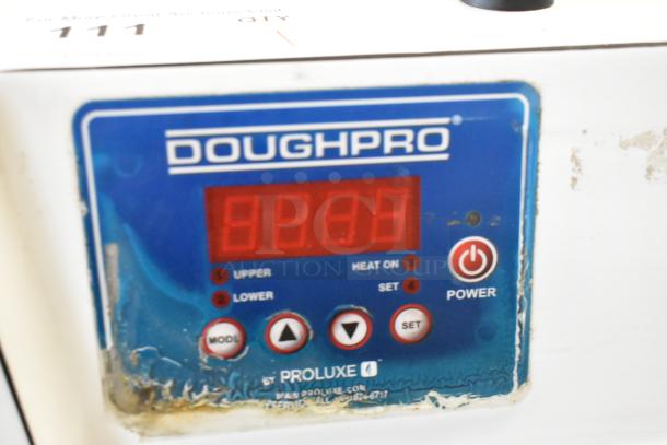 DoughPro metal commercial countertop dough press, blue control panel with digital display and mode settings, on stainless steel stand.