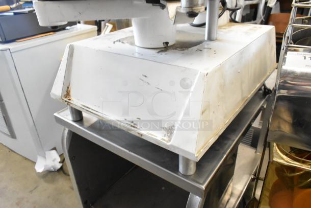 DoughPro metal commercial countertop dough press on stainless steel stand, 115 volts, 1 phase, showing signs of wear.