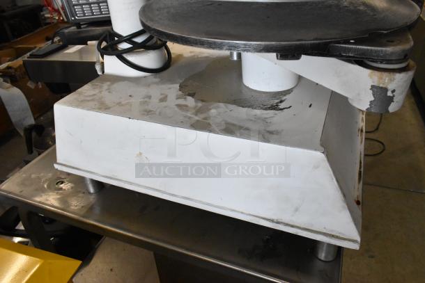 DoughPro metal dough press on stainless steel stand, 115 volts, 1 phase. Shows wear with surface marks.