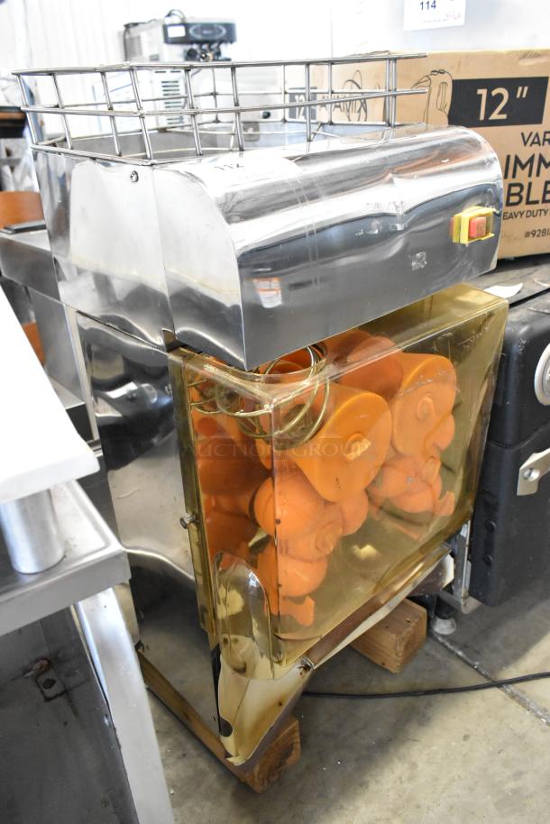 Stainless steel commercial countertop citrus juicer, 115 volts, 1 phase, with orange juicing components, in good condition.