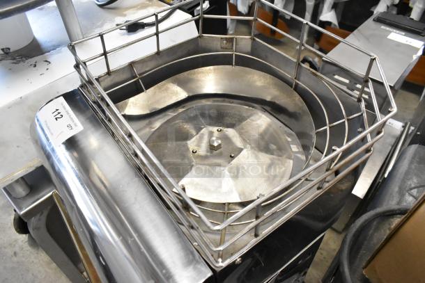 Stainless steel commercial countertop citrus juicer, 115 volts, 1 phase. Features a metal juicing basket and sturdy design.