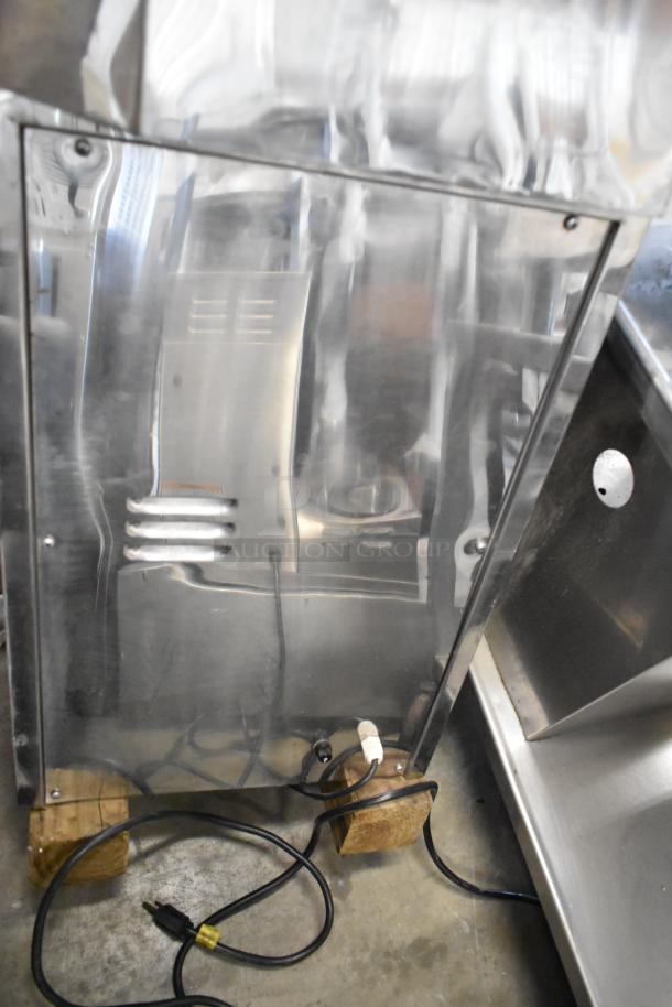 Stainless steel commercial countertop citrus juicer, 115 volts, 1 phase, excellent condition with visible power cord.