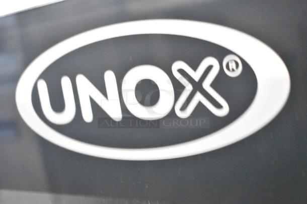 Unox Cadco XAV305 convection oven logo detail, emphasizing brand recognition for commercial kitchen appliances.