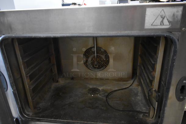 Unox Cadco XAV305 stainless steel commercial convection oven, 208-240V. Interior view shows fan and racks, used condition.