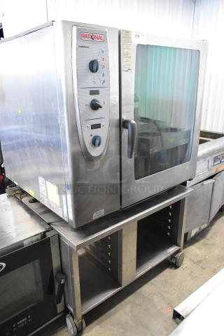 Rational SelfCooking Center commercial combi convection oven on a double pan rack stand with casters, stainless steel.